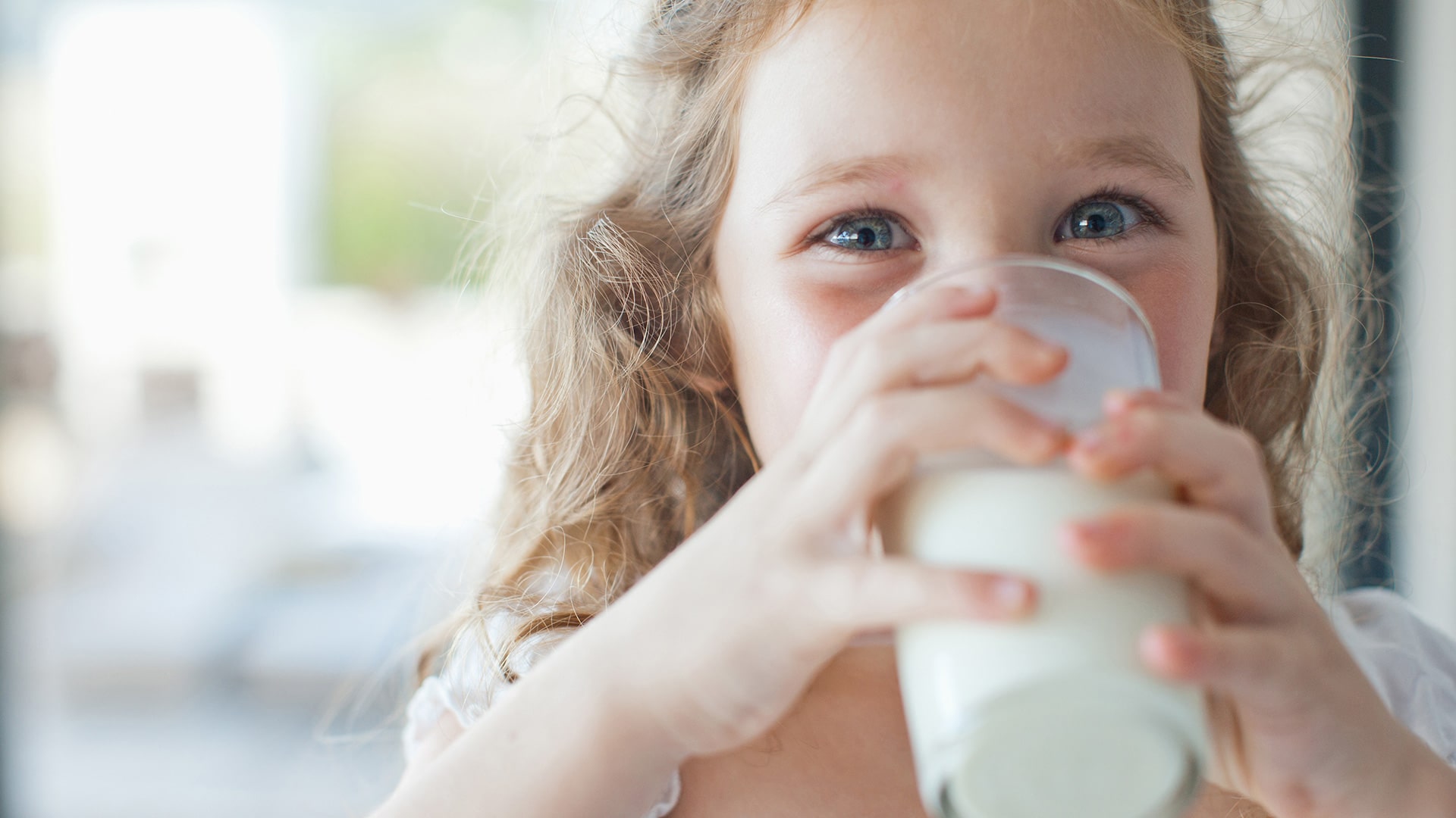 Little girl dinking Tebra milk